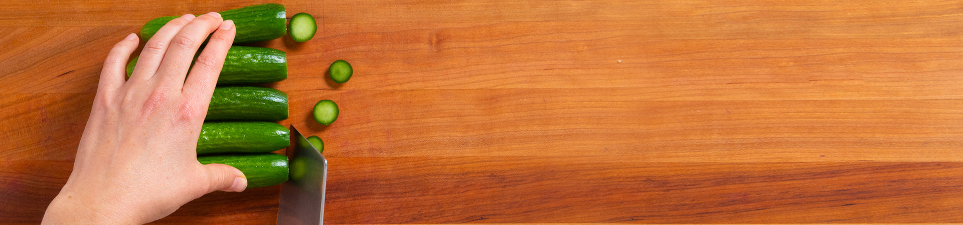 a pair of hands chopping zucchini