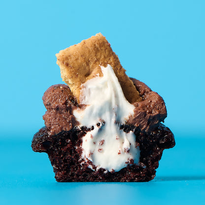 S'mores cupcake with marshmallow and graham cracker on a blue background